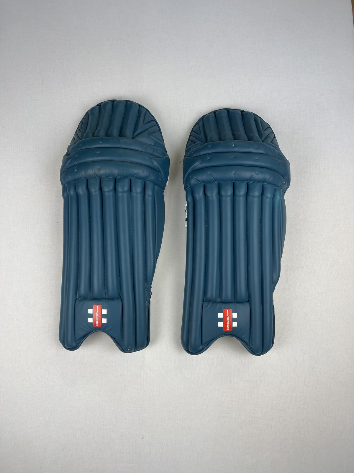 Gray-Nicolls Legend teal youth cricket pads, front