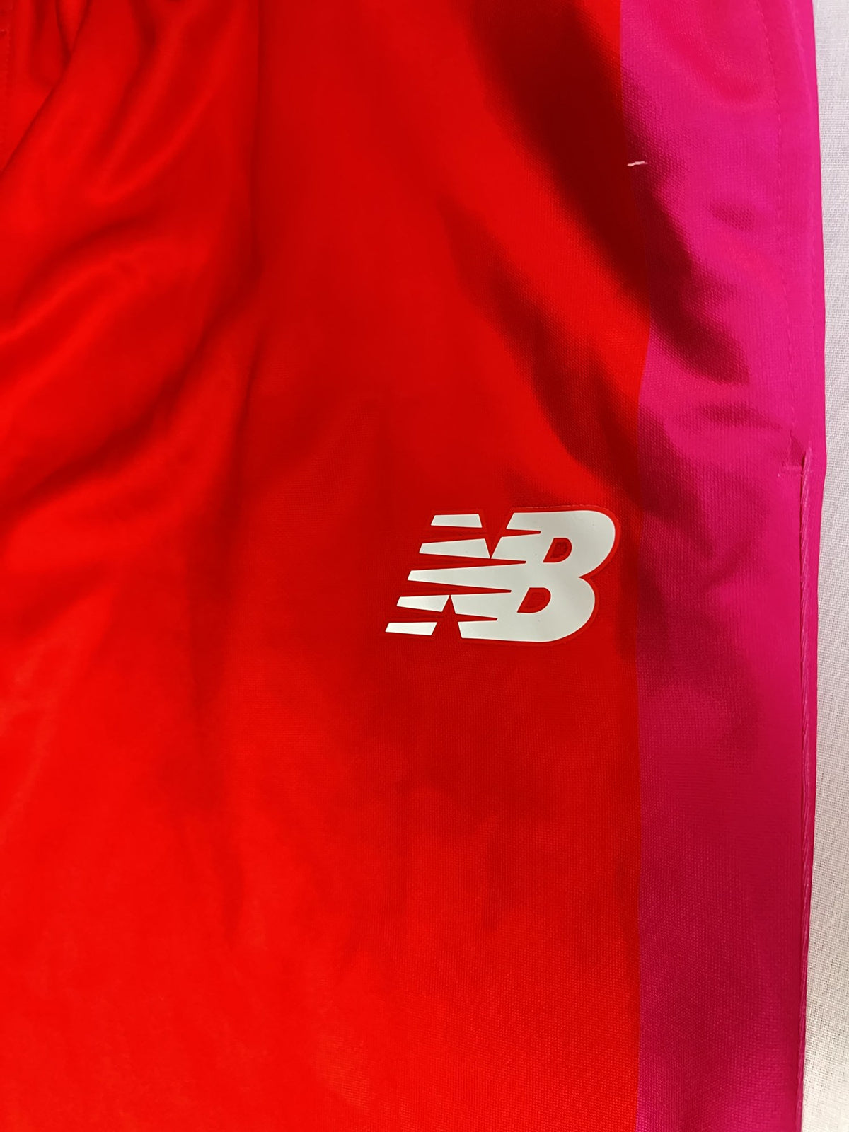 New Balance logo and pink stripe