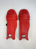 New Balance red youth cricket pads, front