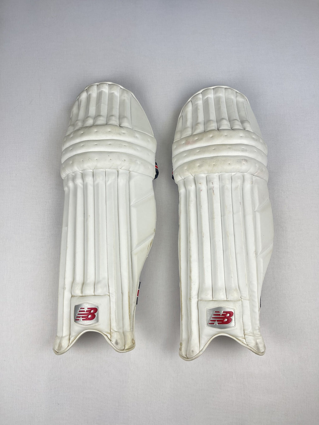New Balance white senior cricket pads, front