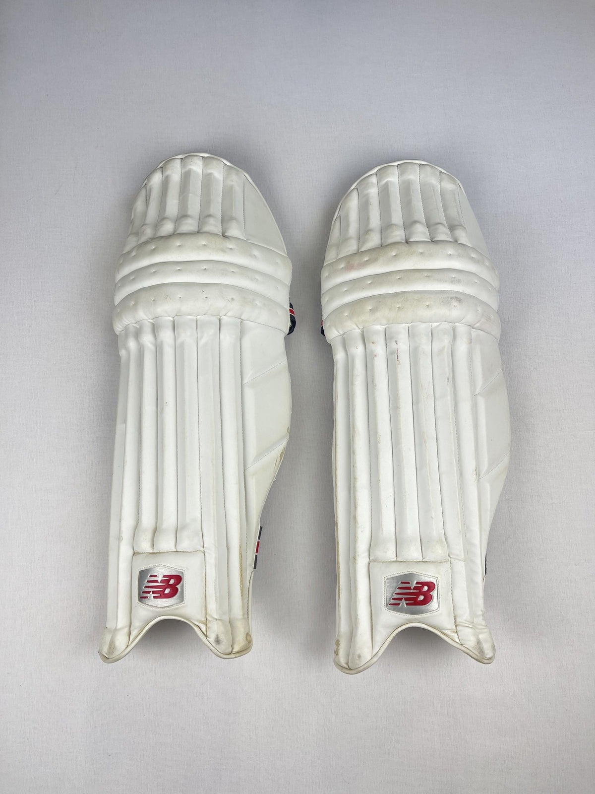 New Balance white senior cricket pads, front